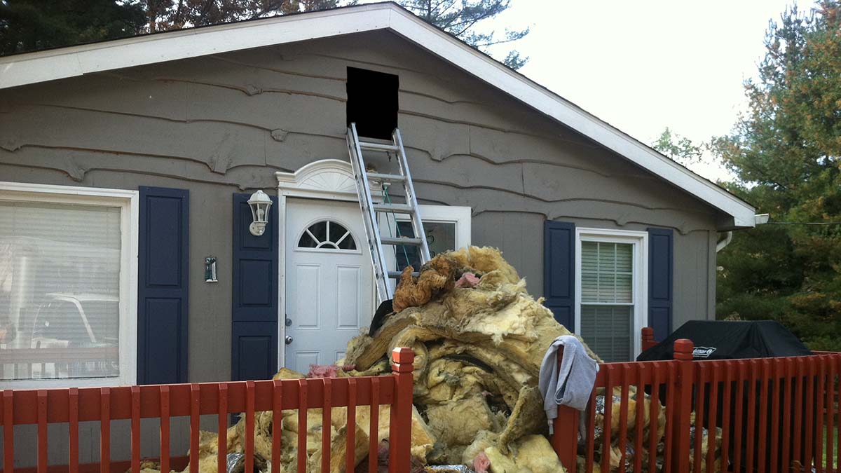 Technician removing contaminated attic insulation in Bloomington